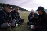 A group of Kazakh elders socialize and drink in the early evening.